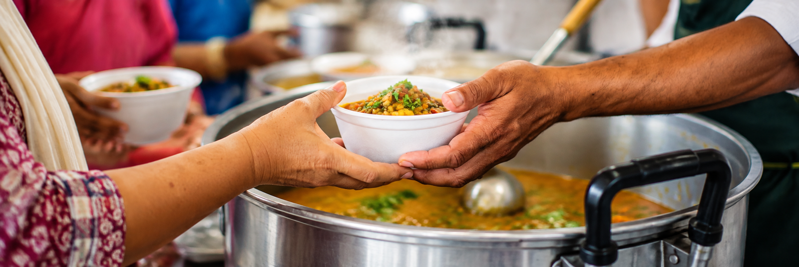 Volunteers offering food to people