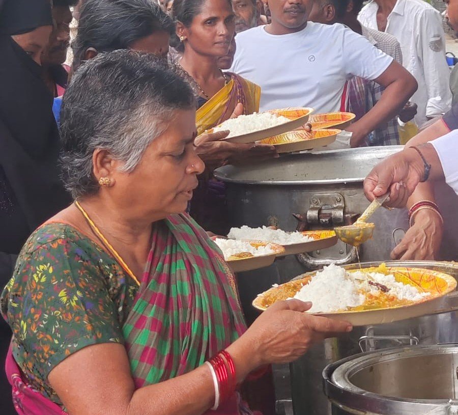 Volunteers distributing meals to people